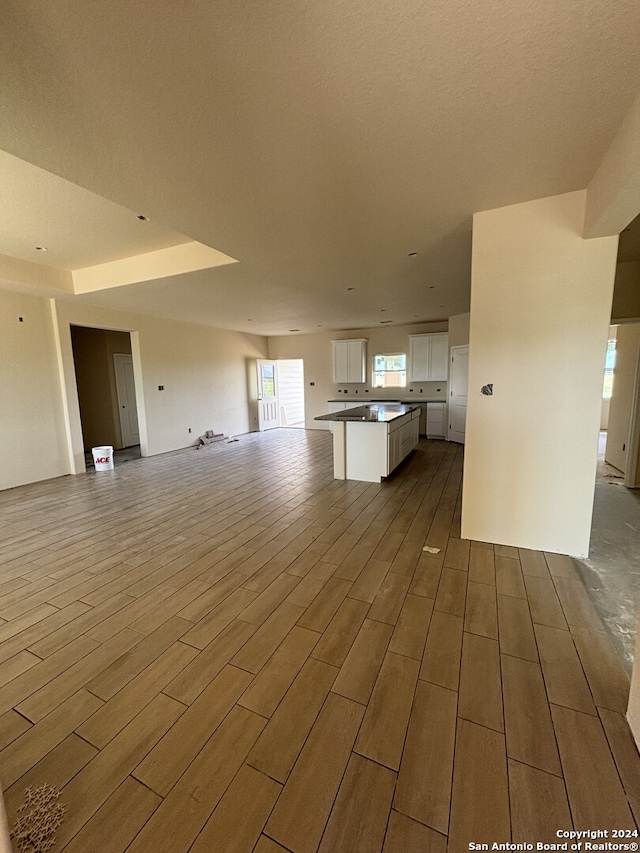 unfurnished living room featuring a textured ceiling and hardwood / wood-style flooring