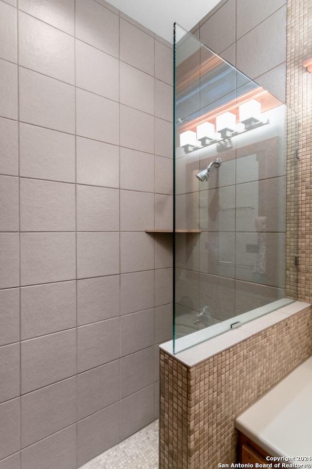 bathroom with a tile shower