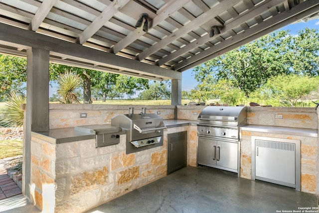 view of patio with area for grilling and a grill