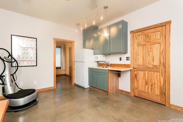 kitchen with white appliances, baseboards, a sink, finished concrete floors, and light countertops
