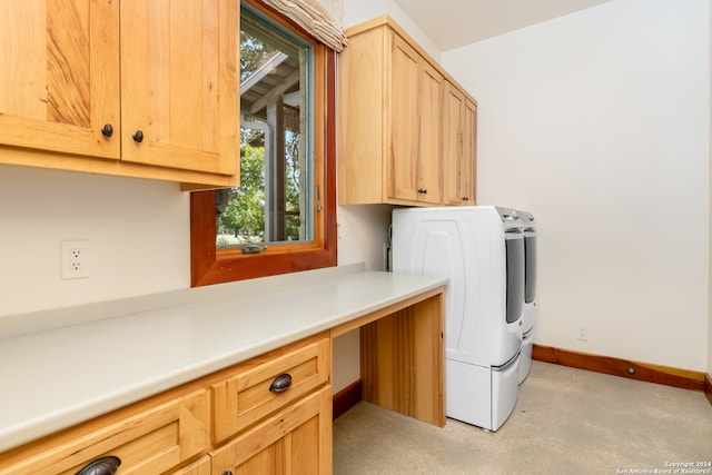 washroom with cabinets and washing machine and dryer