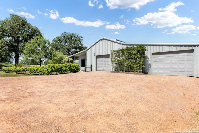 view of side of property featuring a detached garage and board and batten siding