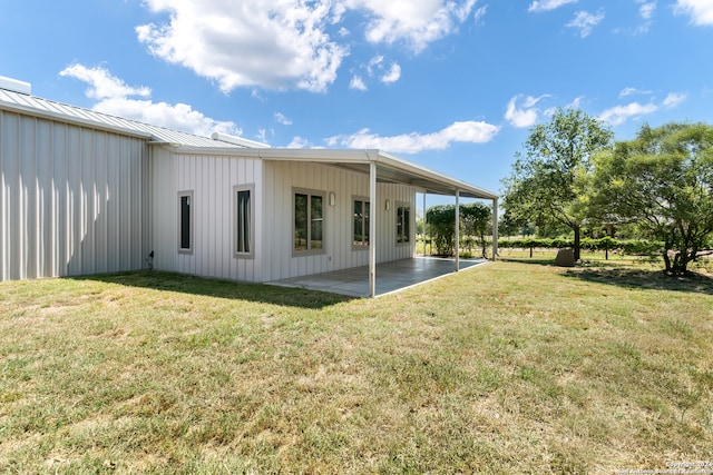 back of property with a patio area and a lawn