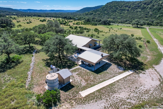 birds eye view of property featuring a mountain view and a rural view