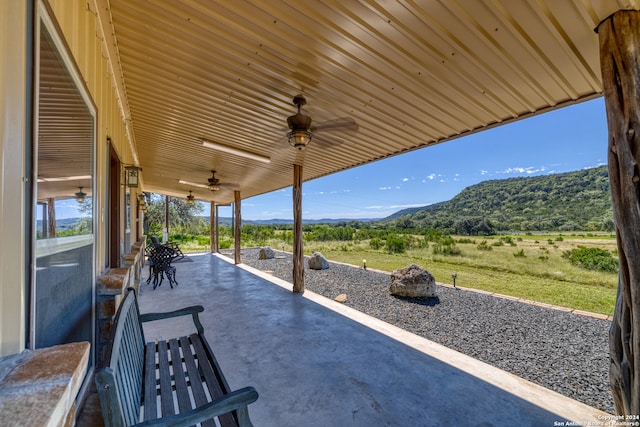 view of patio / terrace featuring a mountain view, a rural view, and ceiling fan