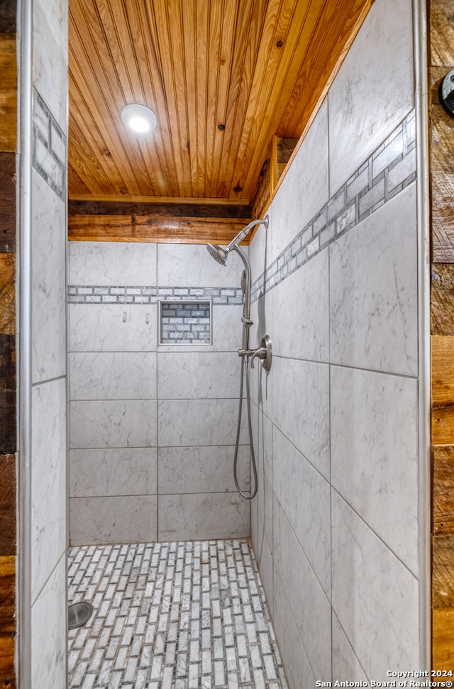 bathroom with wood ceiling and a shower