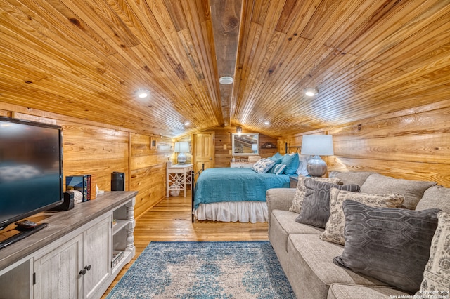 bedroom with wood walls, wood ceiling, light hardwood / wood-style floors, and vaulted ceiling