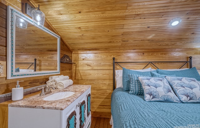 interior space with vanity, vaulted ceiling, wood walls, hardwood / wood-style floors, and wood ceiling