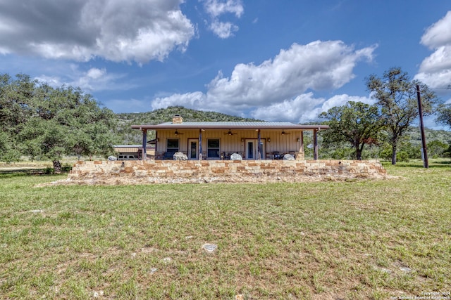 rear view of property with a lawn