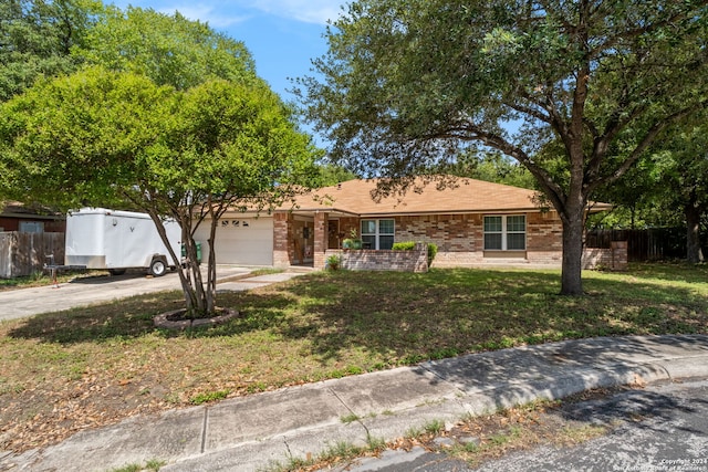 single story home with a front lawn and a garage