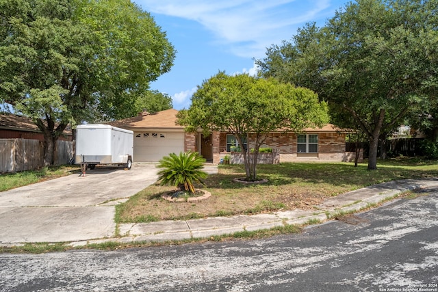 single story home with a garage and a front lawn