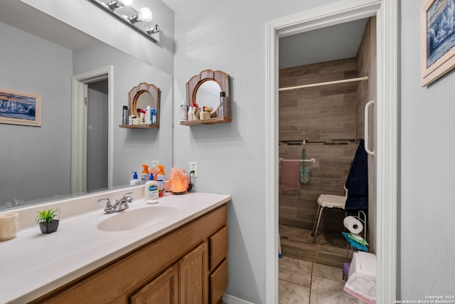 bathroom with vanity, tile patterned floors, and a tile shower