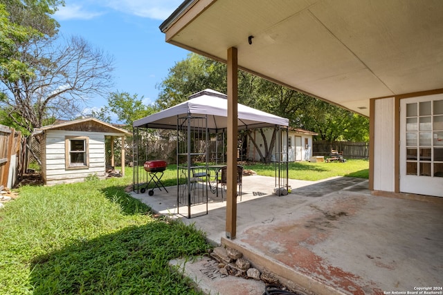 exterior space featuring a patio area, a gazebo, and a storage shed