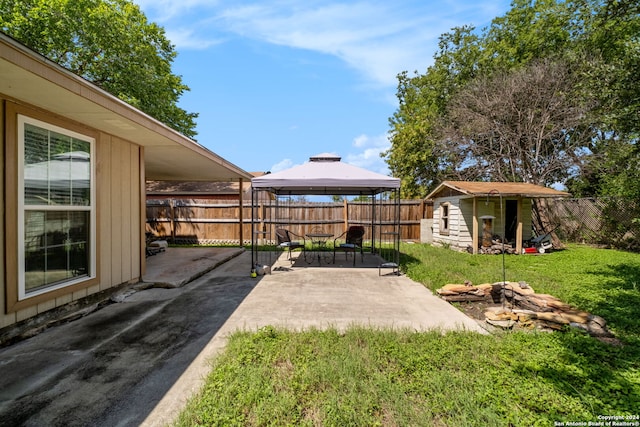 view of yard with a storage unit, a gazebo, and a patio