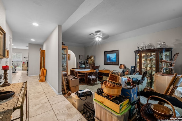 interior space with light tile patterned floors and ceiling fan