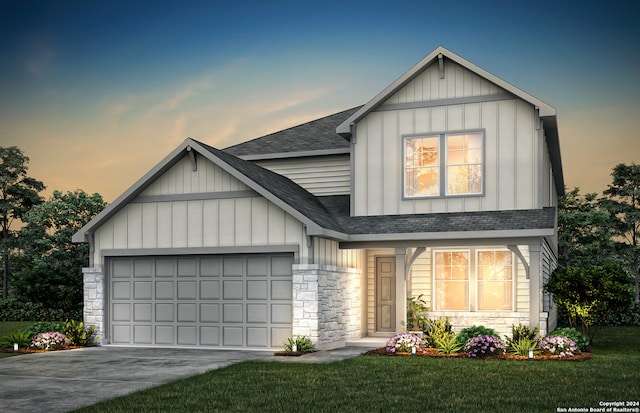 view of front facade with a garage and a yard