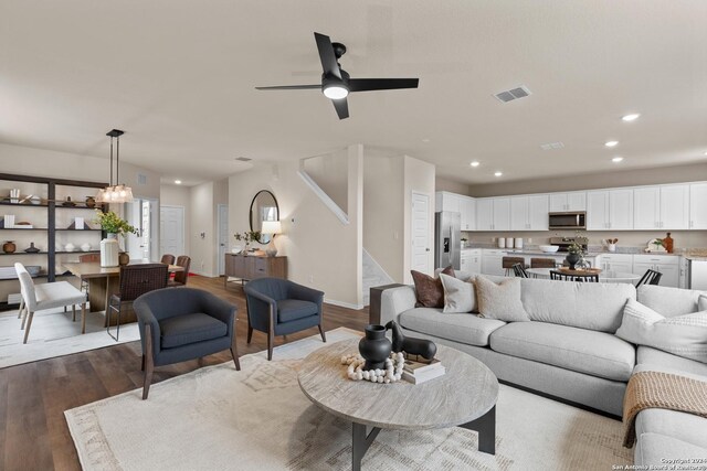 10403 Gibbons Crk, San Antonio, TX 78252 - living room featuring wood finished floors, stairs, recessed lighting, ceiling fan, and baseboards