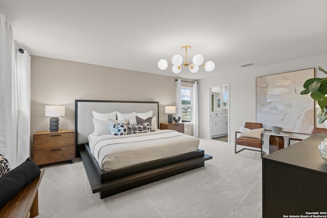 bedroom with ensuite bath, light carpet, and an inviting chandelier