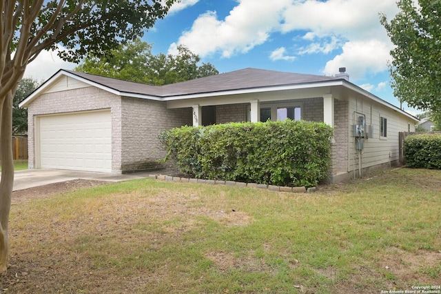 view of front of property featuring a front yard, an attached garage, brick siding, and concrete driveway