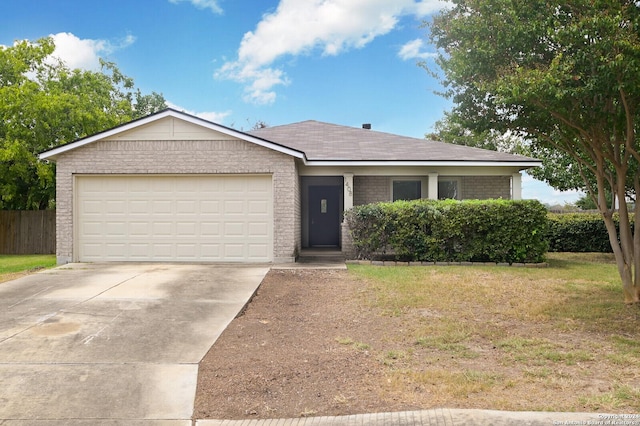 view of front of property featuring concrete driveway, fence, an attached garage, a front lawn, and brick siding