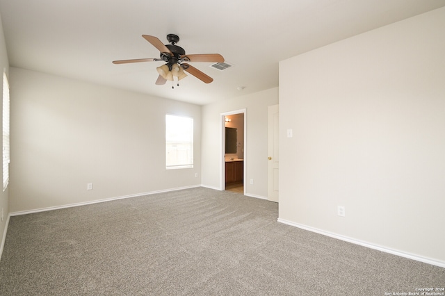 carpeted empty room featuring ceiling fan