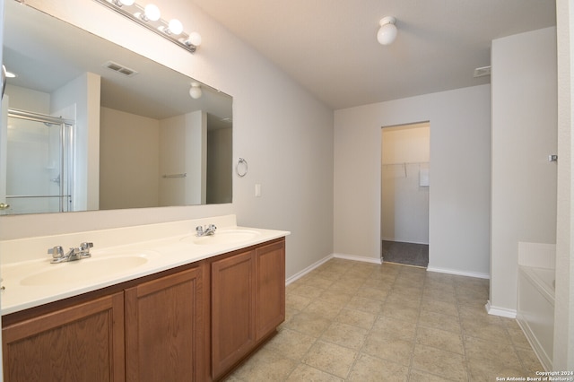 bathroom featuring vanity and shower with separate bathtub