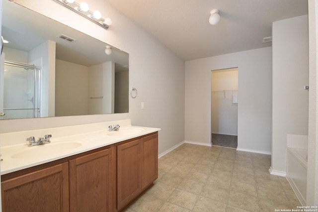 full bathroom featuring double vanity, a sink, visible vents, and a shower stall