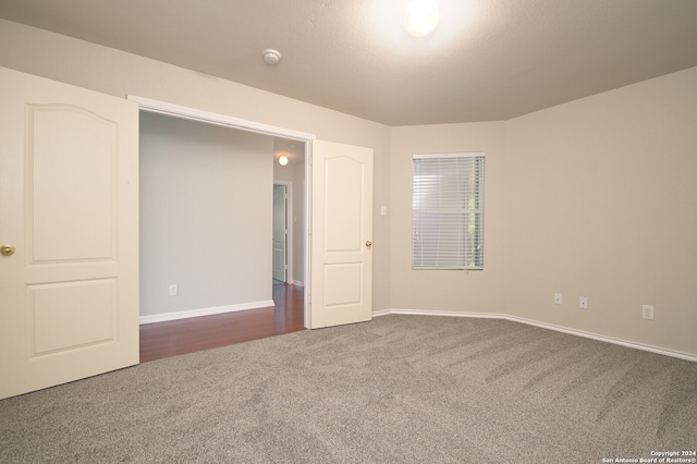 unfurnished bedroom featuring dark colored carpet