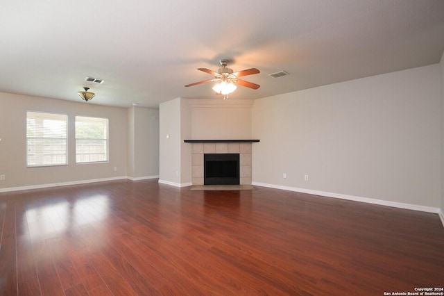 unfurnished living room featuring dark wood-style floors, visible vents, baseboards, and a ceiling fan