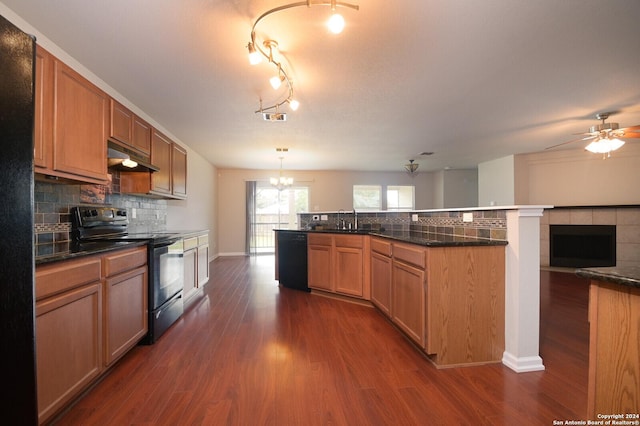 kitchen with open floor plan, dark wood-style flooring, backsplash, a sink, and black appliances