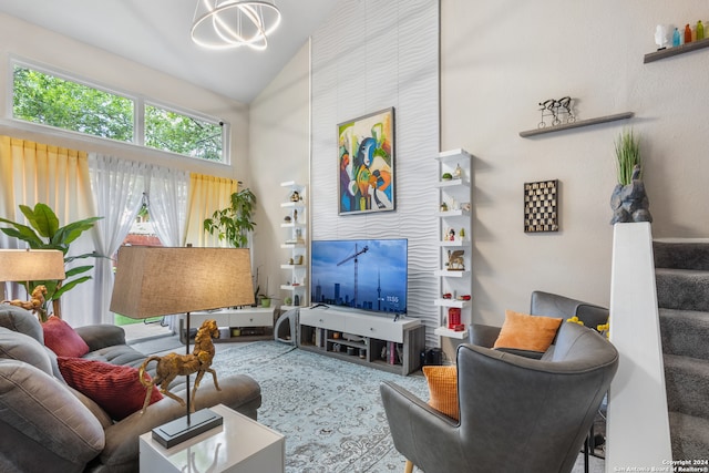 living room with high vaulted ceiling and a chandelier