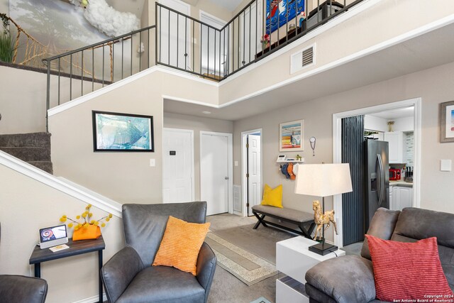 living room with a towering ceiling