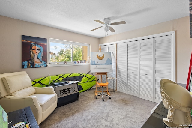 interior space with a closet, ceiling fan, and a textured ceiling