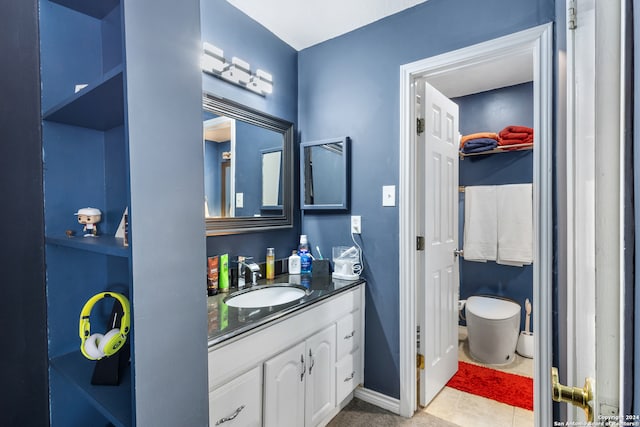 bathroom featuring vanity, toilet, and tile patterned flooring