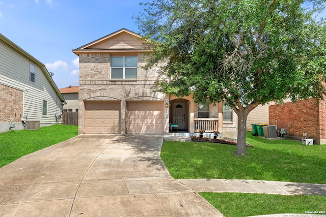 view of front of home with a garage, covered porch, central AC unit, and a front yard