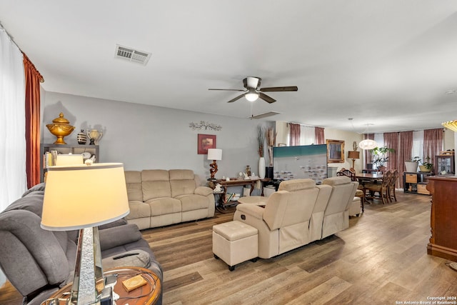 living room featuring ceiling fan and light hardwood / wood-style flooring