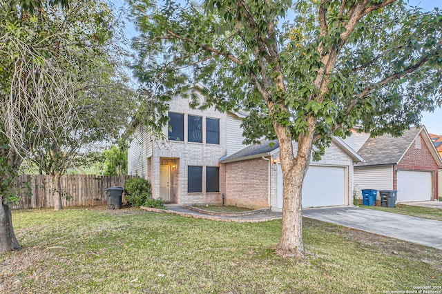 view of front of property with a garage and a front yard