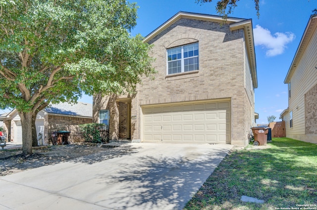 view of front of property with a garage and a front lawn