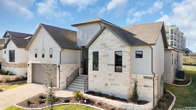 view of front of house with concrete driveway, stucco siding, stone siding, and a shingled roof