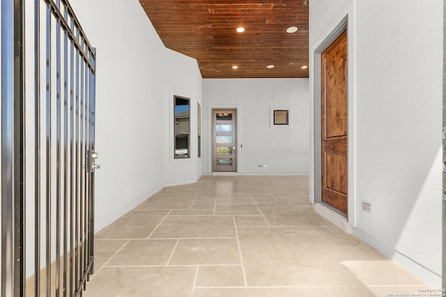 corridor with light tile patterned flooring, wood ceiling, and recessed lighting