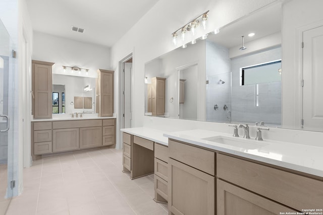 full bath featuring tile patterned flooring, a shower stall, visible vents, and a sink