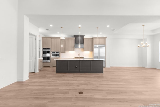 kitchen featuring recessed lighting, appliances with stainless steel finishes, light wood-type flooring, and light countertops