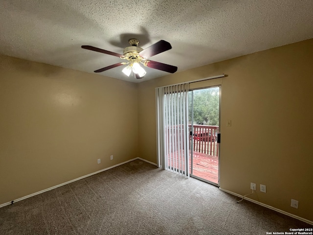 carpeted spare room featuring ceiling fan and a textured ceiling