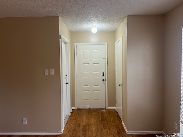 entryway featuring a textured ceiling and hardwood / wood-style flooring