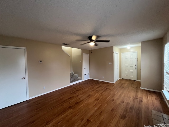 interior space featuring a textured ceiling, wood-type flooring, and ceiling fan