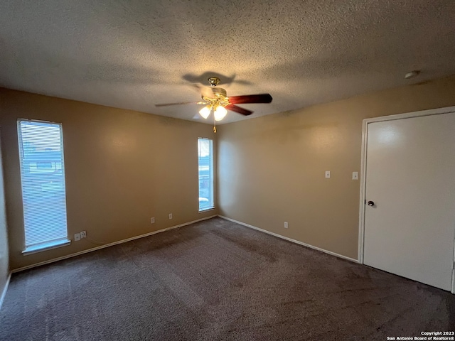 unfurnished room with a textured ceiling, carpet flooring, and ceiling fan