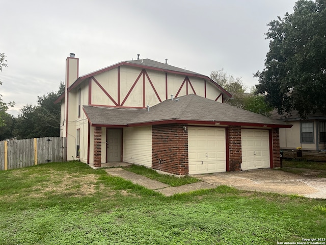 tudor-style house with a garage and a front yard