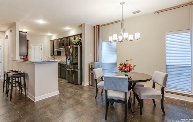 dining space with a notable chandelier