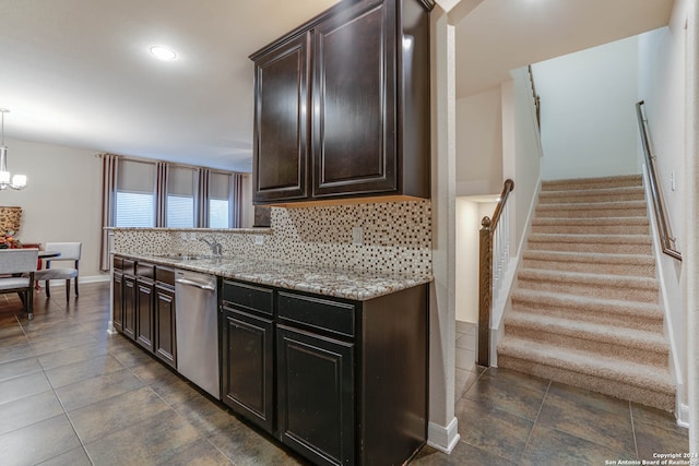 kitchen featuring sink, hanging light fixtures, backsplash, dark brown cabinetry, and stainless steel dishwasher