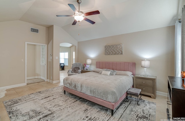 tiled bedroom with lofted ceiling and ceiling fan